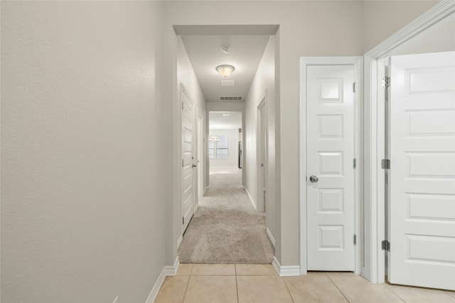 hallway with light tile patterned floors