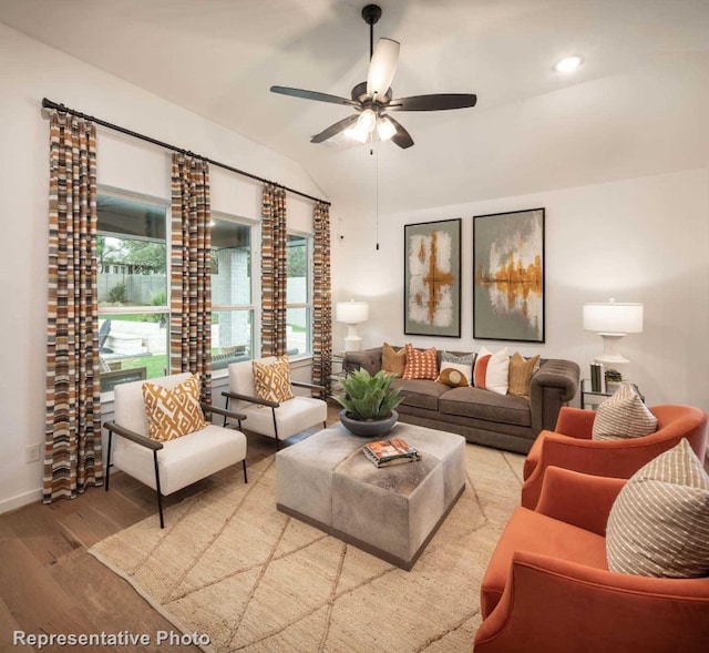 living room with light wood-type flooring, ceiling fan, and lofted ceiling