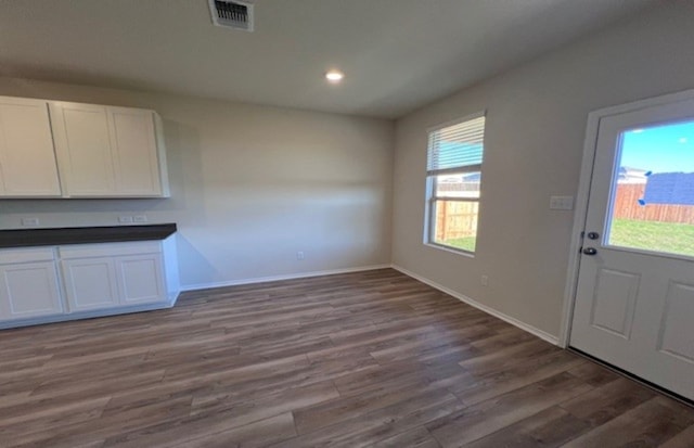 unfurnished dining area featuring hardwood / wood-style flooring