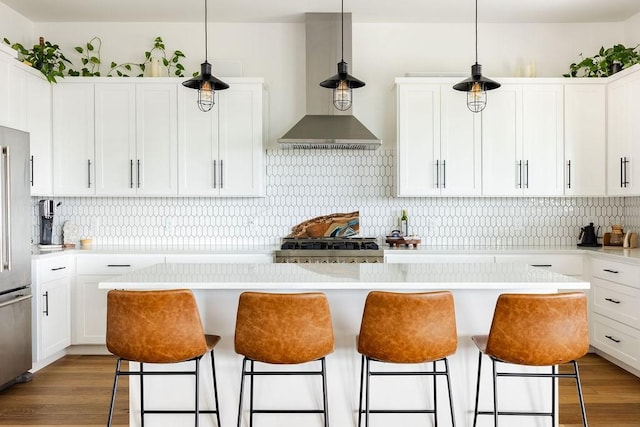 kitchen featuring white cabinets, pendant lighting, a center island, and hardwood / wood-style flooring