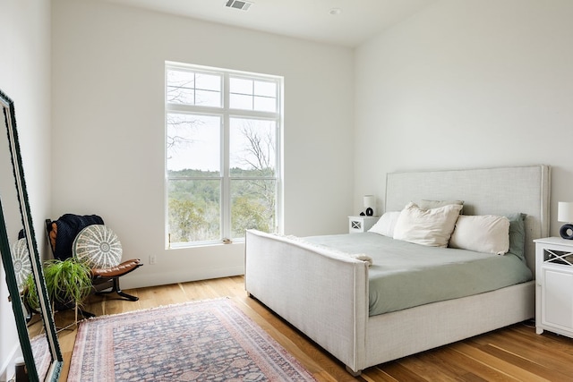 bedroom with wood-type flooring