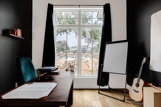 home office featuring a healthy amount of sunlight and light wood-type flooring