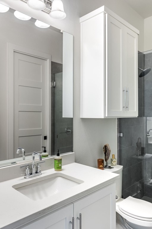 bathroom featuring vanity, toilet, and an enclosed shower