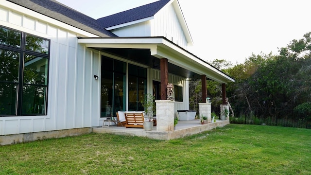 view of property exterior featuring a lawn and a patio