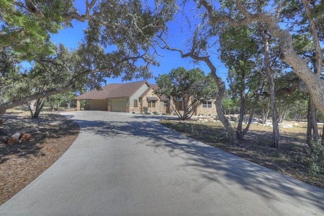 121 Winecup Ln, Spring Branch, TX 78070 - view of front of property with a garage, concrete driveway, and stone siding