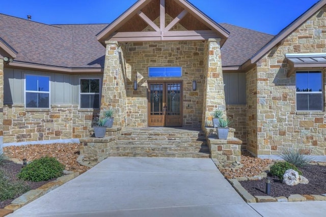 121 Winecup Ln, Spring Branch, TX 78070 - property entrance featuring stone siding, french doors, roof with shingles, and board and batten siding
