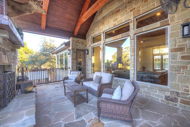 view of patio with an outdoor living space with a fireplace