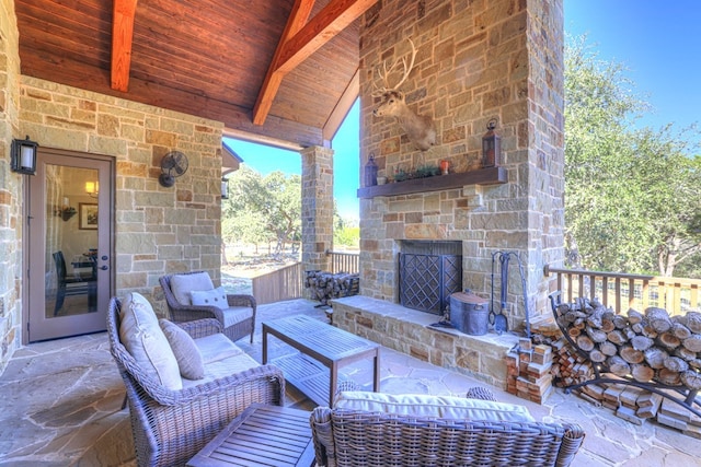 view of patio / terrace featuring an outdoor stone fireplace