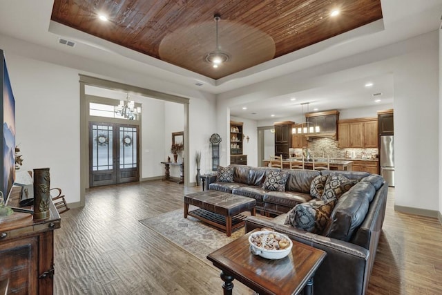 121 Winecup Ln, Spring Branch, TX 78070 - living room featuring a tray ceiling, wood ceiling, wood finished floors, a chandelier, and recessed lighting