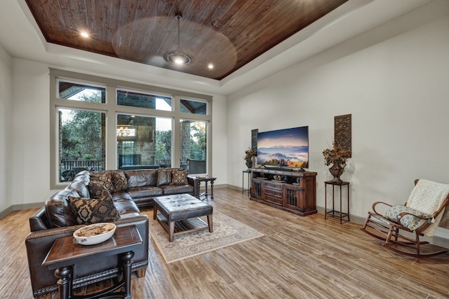 living room with hardwood / wood-style floors, wood ceiling, and a tray ceiling