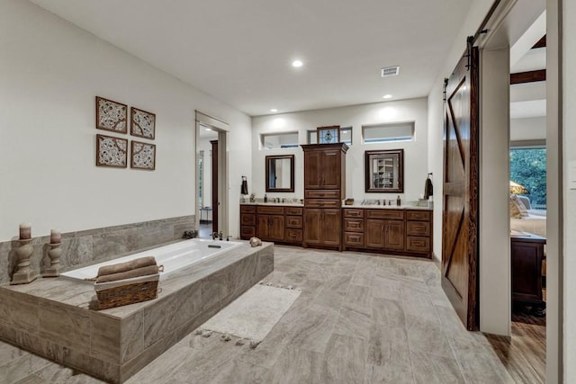 121 Winecup Ln, Spring Branch, TX 78070 - full bathroom with double vanity, a garden tub, and marble finish flooring