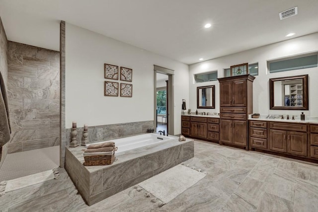 121 Winecup Ln, Spring Branch, TX 78070 - bathroom with a bath, double vanity, recessed lighting, and a walk in shower