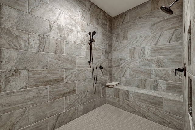 bathroom with a tile shower