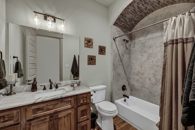 full bathroom with shower / bath combination with curtain, vanity, hardwood / wood-style flooring, and toilet