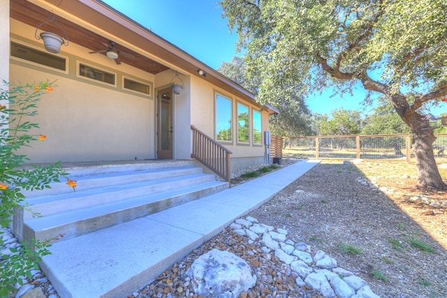 entrance to property featuring ceiling fan