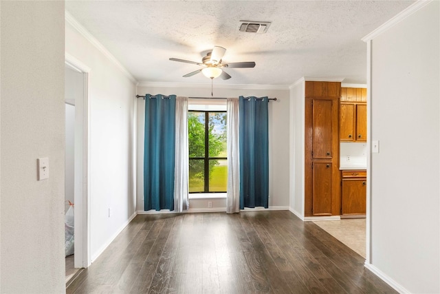 unfurnished room featuring a textured ceiling, ceiling fan, crown molding, and dark wood-type flooring