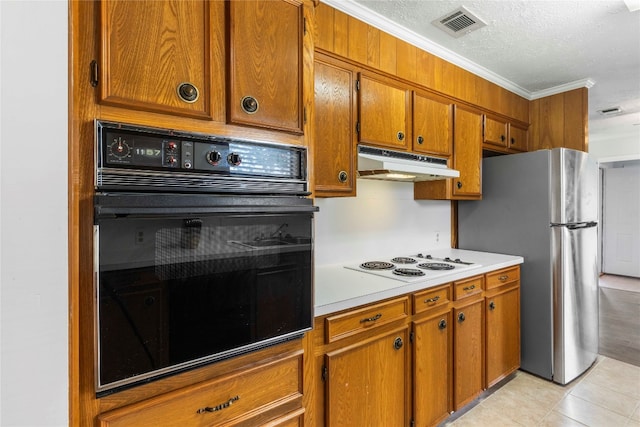 kitchen with light tile patterned flooring, a textured ceiling, crown molding, oven, and white electric stovetop