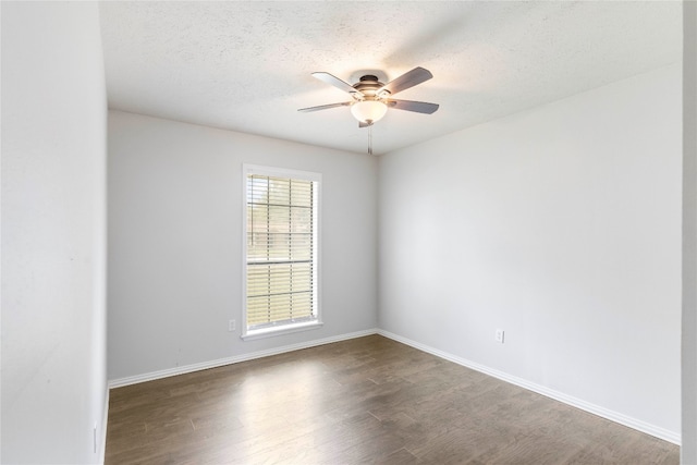 spare room with a textured ceiling, dark hardwood / wood-style flooring, and ceiling fan