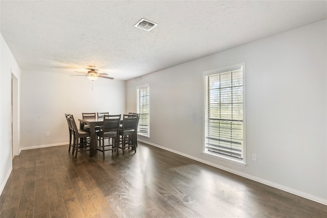 dining area featuring a textured ceiling, dark hardwood / wood-style flooring, and ceiling fan