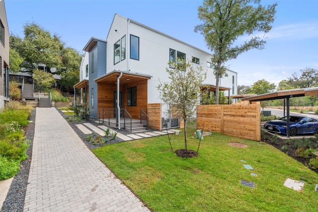 contemporary house featuring a front yard and a porch