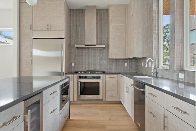 900 S 2nd St Unit 18, Austin, TX 78704 - kitchen featuring built in appliances, wall chimney exhaust hood, wine cooler, a sink, and backsplash