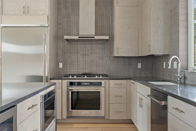 900 S 2nd St Unit 18, Austin, TX 78704 - kitchen with stainless steel appliances, wall chimney range hood, a sink, decorative backsplash, and wine cooler