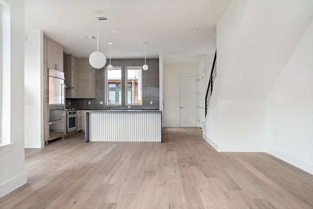 900 S 2nd St Unit 18, Austin, TX 78704 - kitchen with appliances with stainless steel finishes, open floor plan, decorative backsplash, light wood-style flooring, and recessed lighting