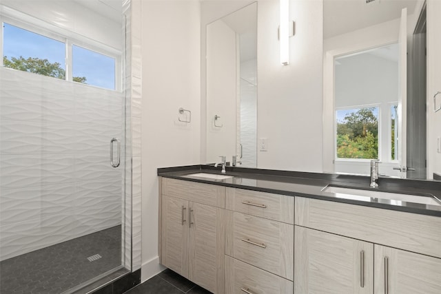 bathroom featuring tile patterned flooring, plenty of natural light, vanity, and walk in shower