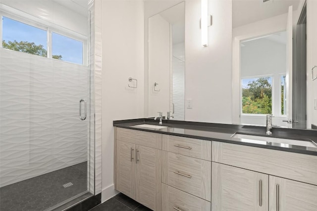 900 S 2nd St Unit 18, Austin, TX 78704 - full bath with double vanity, healthy amount of natural light, a shower stall, and tile patterned floors