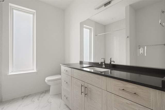 bathroom featuring vanity, toilet, and a tile shower