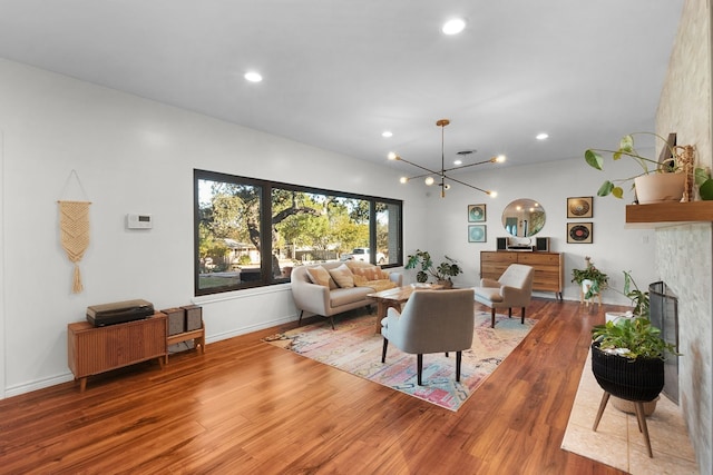 living room with hardwood / wood-style flooring and a notable chandelier