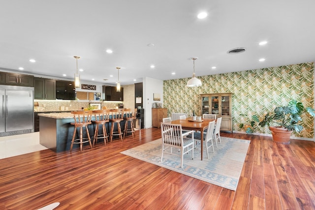 dining space with dark hardwood / wood-style flooring