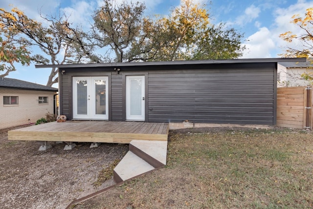 back of property with a deck and french doors