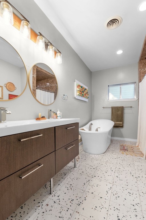 bathroom featuring vanity and independent shower and bath