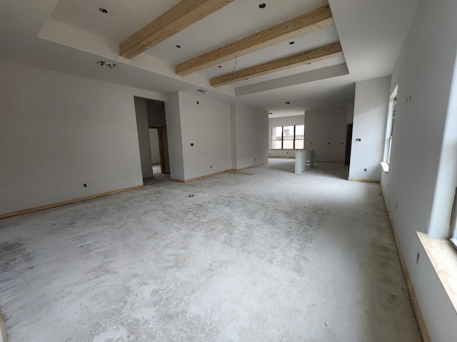 spare room featuring beam ceiling