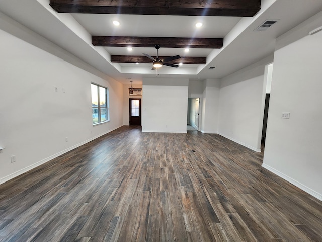 unfurnished living room featuring beamed ceiling, ceiling fan, and dark hardwood / wood-style flooring