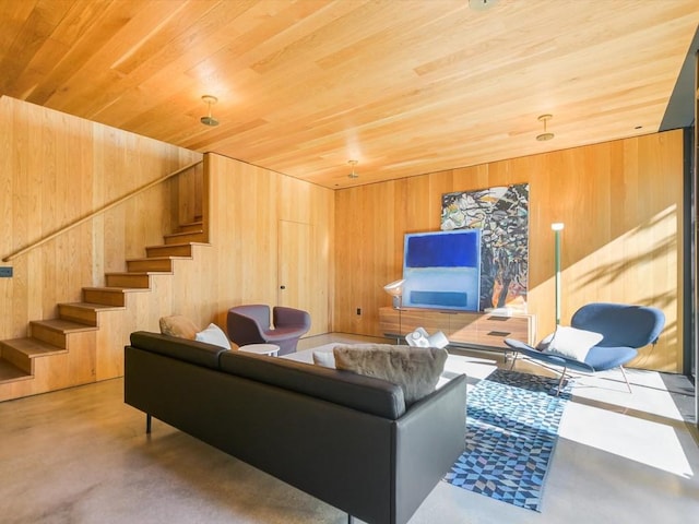 living room with wood ceiling and wooden walls