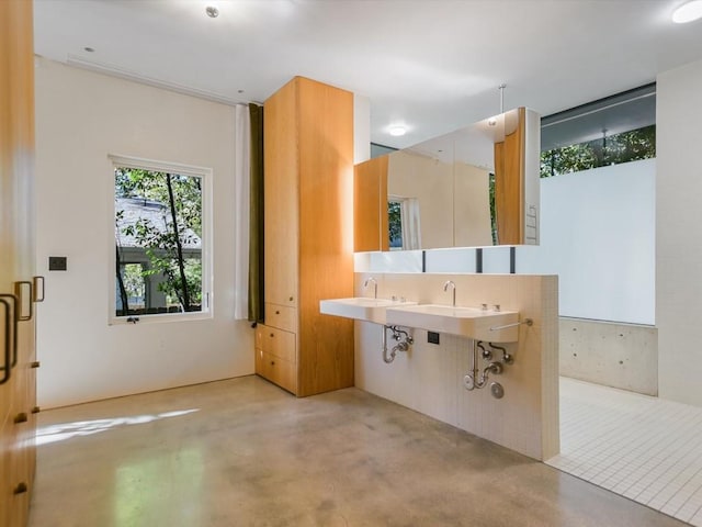 bathroom with concrete flooring