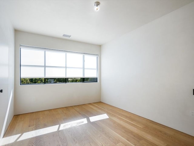 unfurnished room with light hardwood / wood-style floors