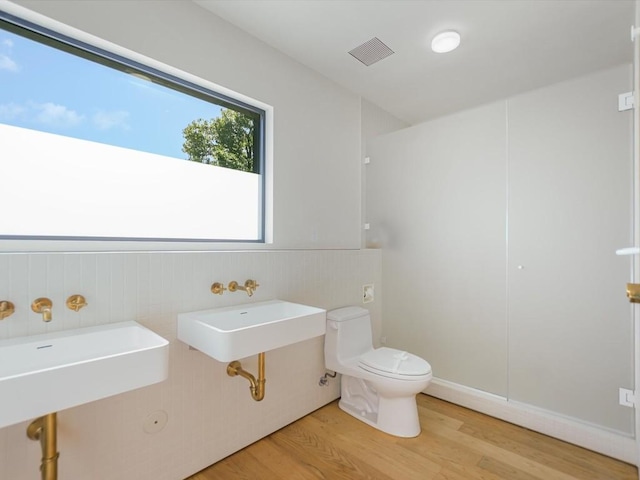 bathroom featuring sink, wood-type flooring, and toilet