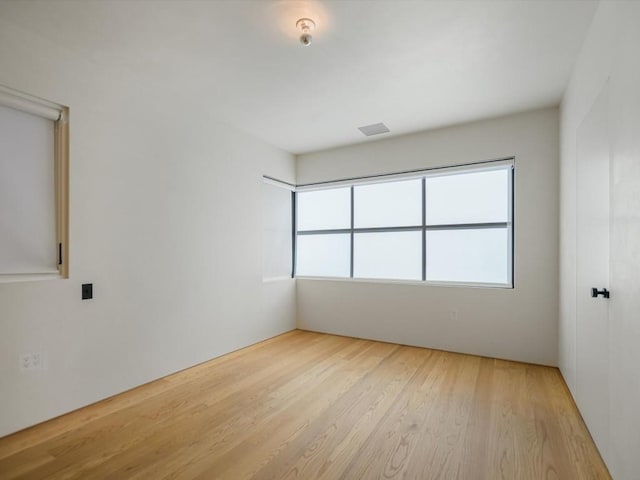 spare room with light hardwood / wood-style flooring