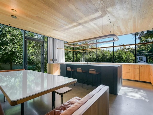 sunroom featuring wooden ceiling