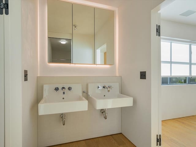 bathroom featuring sink and hardwood / wood-style floors