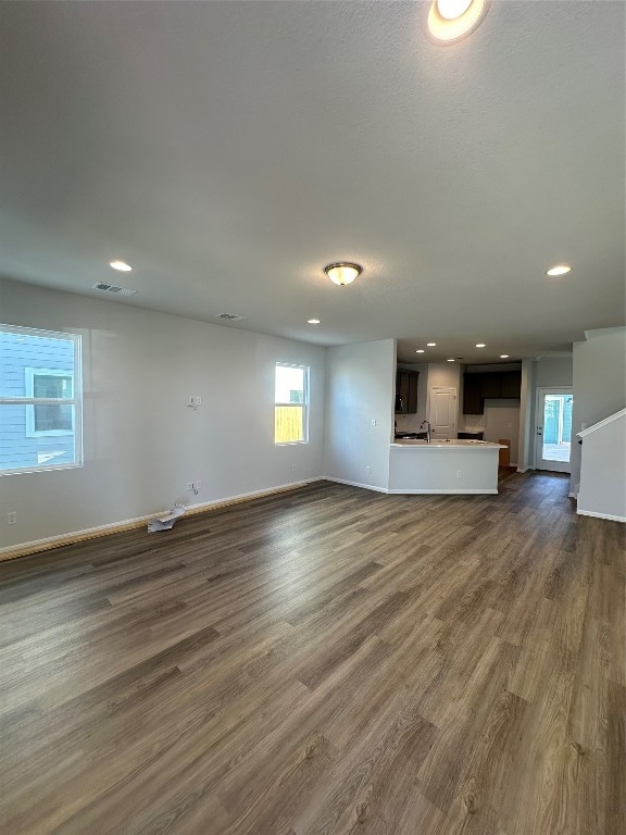 unfurnished living room featuring dark hardwood / wood-style flooring