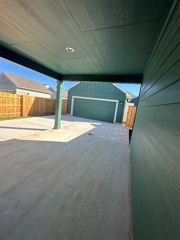 view of patio / terrace with an outbuilding and a garage