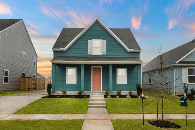 bungalow-style home featuring a yard and covered porch