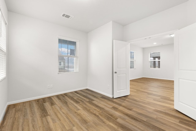 unfurnished room with wood-type flooring