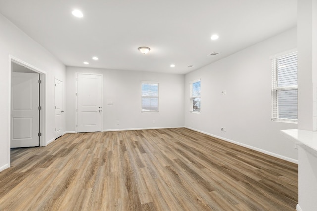 empty room with light hardwood / wood-style flooring