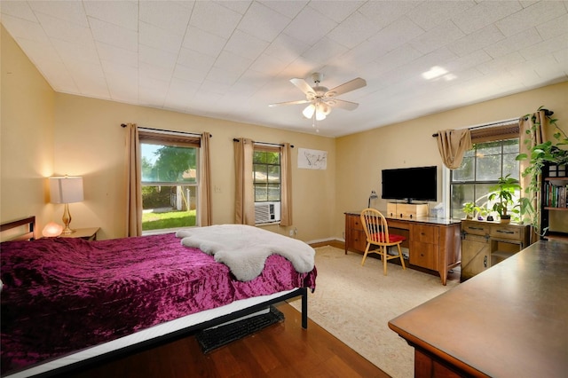 bedroom featuring light hardwood / wood-style flooring, multiple windows, and ceiling fan