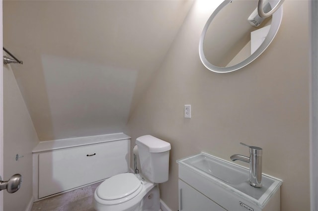 bathroom with vaulted ceiling and toilet